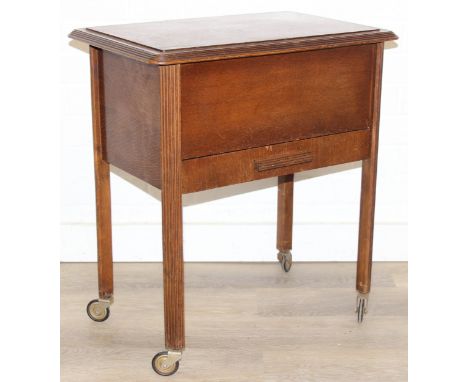 A vintage oak sewing box on wheels with vintage contents inc cotton reels, 56cm x 37cm x 62cm