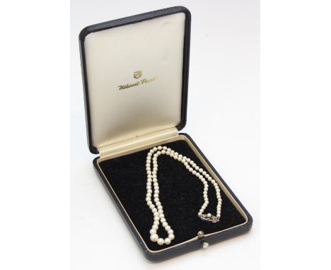 A vintage Mikimoto cultured pearl necklace in original box, silver clasp with monogram M, the largest pearl 7.5mm in diameter