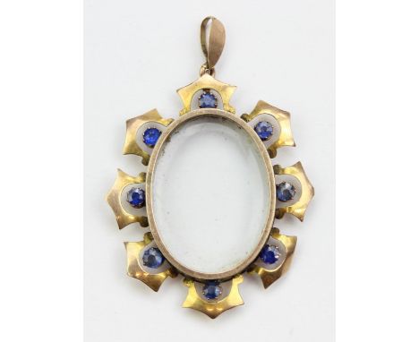 [4.56g] - an antique 9ct gold and blue stone pendant or locket, the central glass recess surrounded by eight blue stones, bel