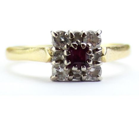[3.32g, K] - an 18ct yellow gold ring set with a central ruby surrounded by small diamonds in a square setting, marked for Ed