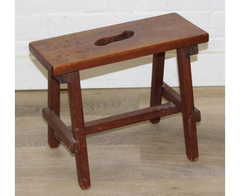 A small rustic mahogany stool with cut out to top, early 20th century, 38cm wide x 30cm tall