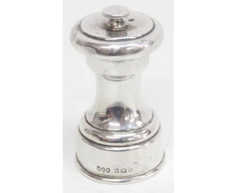 An antique silver pepper mill or grinder, marked for Birmingham 1923 by Hukin &amp; Heath, 9cm tall