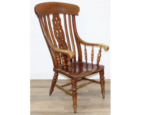 An antique high back Windsor slatback farmhouse armchair with elm seat, 121cm tall