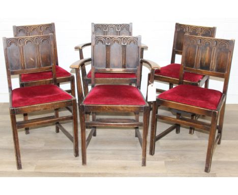 A set of six Jacobean style dining chairs by Ercol, with red velvet seats, two carver chairs and four dining chairs, each 82c