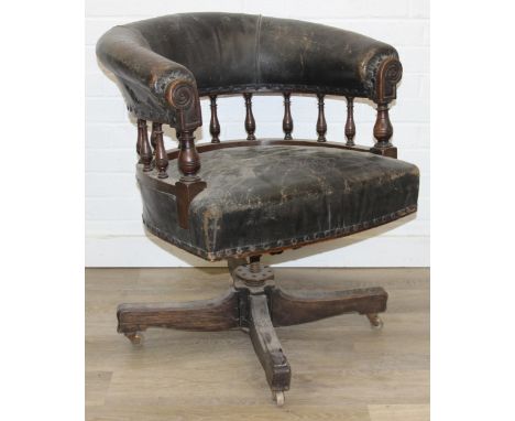 A vintage leather desk chair with low back and carved exposed frame, distressed upholstery, 71cm wide x 78cm tall