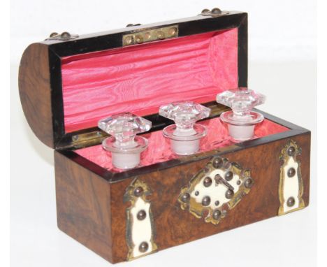 A Victorian Gothic Revival walnut, ivorine and gilt metal mounted domed top scent bottle casket, the hinged lid opening to re