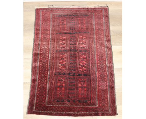A vintage Turkoman rug of red ground, 155cm x 105cm