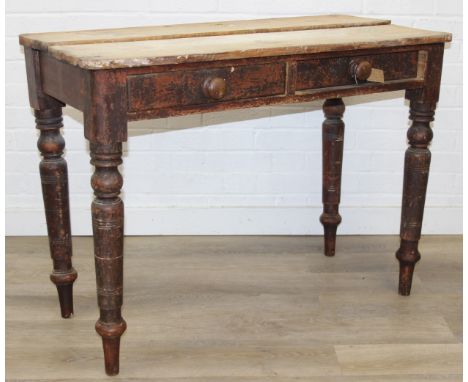 A rustic pine side table with two drawers, 19th century with turned legs, stripped top, 102cm x 49cm x 76cm