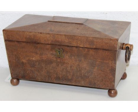 An antique mahogany sarcophagus tea caddy with turned feet and ring handles, three compartment interior, 35cm wide
