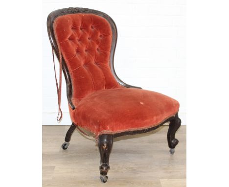 A 19th century low chair with shaped button back and exposed carved frame, 87cm tall
