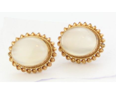 [2.59g] - a pair of 9ct gold and moonstone stud earrings with rope twist border, the posts marked and XRF confirmed, each 14m