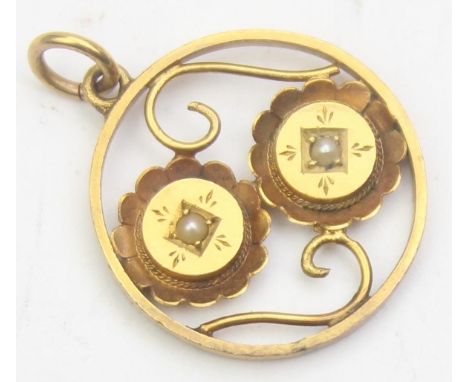[2.24g] - an antique 15ct gold pendant in the Glasgow School Art Nouveau taste, two entwined flowers set with seed pearls, ma
