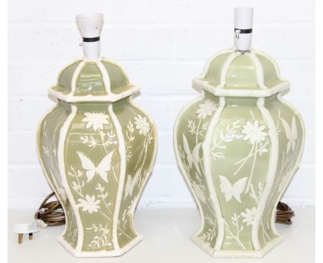 A pair of Chinese style pottery table lamps, the body formed as a Celadon hexagonal green base decorated with white flowers a
