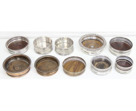 A qty of antique and later silver-plated wine bottle coasters, many with pierced design, one pair [10]