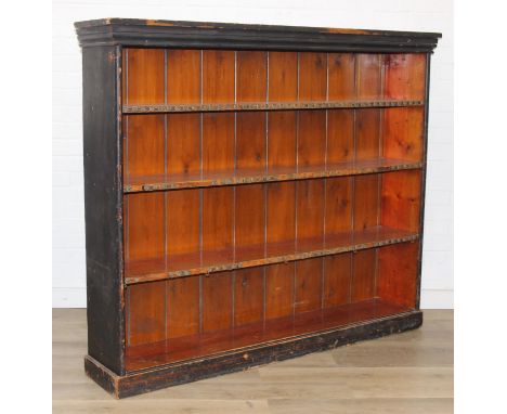 An antique black painted pine bookcase with decorative roundels to shelf, approx 161cm x 30cm x 134cm