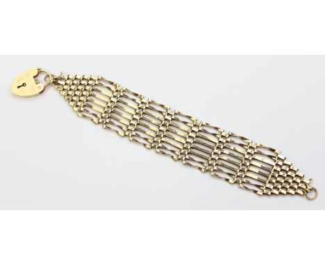 [16.55g] - a vintage 9ct gold eight bar gate bracelet with heart shaped padlock clasp, London 1976, 17cm long