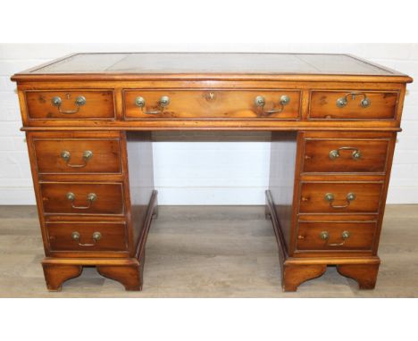 An antique style three part pedestal desk with green inset leather top, 121cm x 60cm x 78cm
