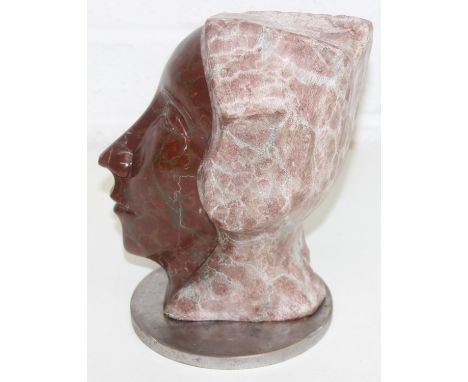 Thierry Auneau (Contemporary, French) - a carved marble sculpture depicting a head, one half of which is completed and the ot