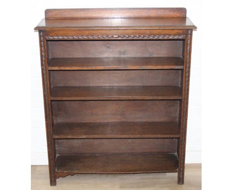 An early 20th century oak bookcase with carved details, with three adjustable shelves, 91cm x 26cm x 113cm