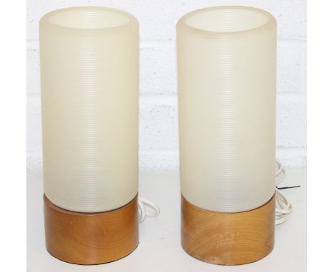 A pair of retro rocket style table lamps with wooden bases and ribbed white plastic shades, each 28cm tall