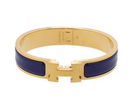 HERMÈS Armreif "CLIC H", NP.: 575,-€. Größe PM. Schmaler Armreif aus Email in Dunkelblau mit goldfarbener Hardware. Staubbeut