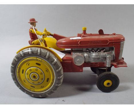 A Vintage Battery Driven Tractor Toy 