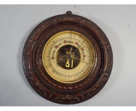 A Late Victorian Carved Oak Wall Barometer (Cracked Glass)