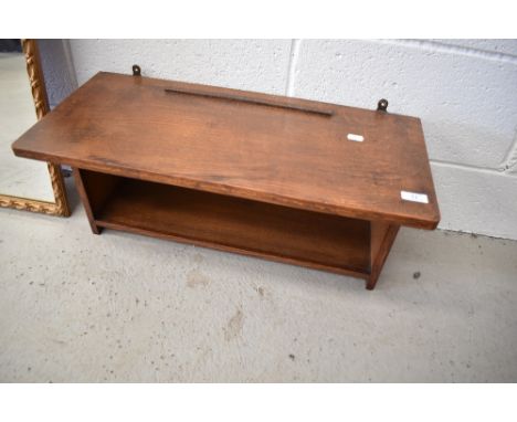 An Arts and Crafts golden oak wall shelf, labelled for Arthur Simpson Handicrafts
Clean and Tidy, patina showing good age, se