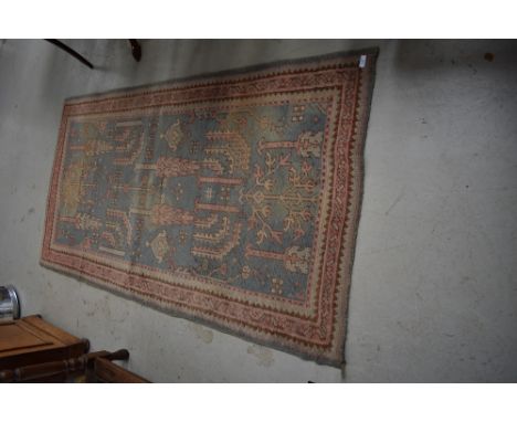 A traditional Persian style rug , edged with branded strip, R W Weekes Ltd, Tunbridge Wells, approx. 175 x 93cm