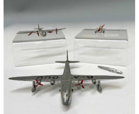 A collection of three Dinky Toys pre-WWII aeroplanes: 60K, a "Light Tourer" Percival Gull, unmarked, silver with red propelle