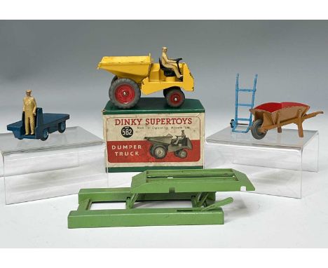 A collection of five items, to include four larger-scale Dinky Toys: a Dumper Truck 562, bright yellow with red hubcaps, stee