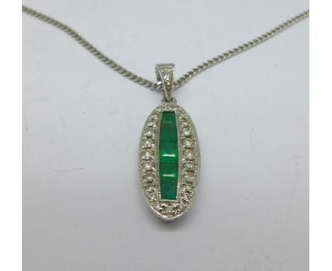 An 18ct white gold, emerald and diamond pendant on an 18ct white gold chain, 5.9g