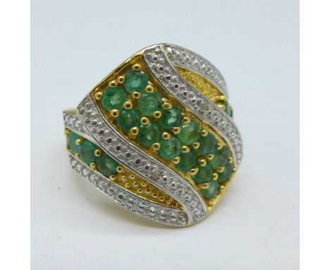 A silver gilt, emerald and diamond ring, R