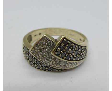 A 9ct gold ring set with black and white diamonds, approximately .50 carat diamond weight, 4.6g, R