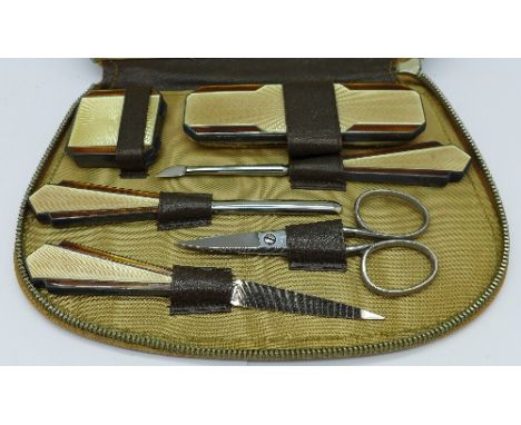 An Art Deco enamelled silver manicure set, Birmingham 1933, maker T&S, with case