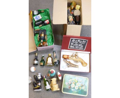 A collection of alcohol miniatures including His and Hers dueling pistols, Lagavulin Scotch whisky, Bells, Glenfiddich, etc.