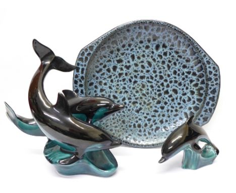 A Poole plate and two Poole dolphin figures