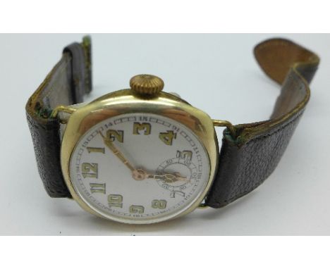 A WWI period rolled gold wristwatch, enamel dial and wire lugs