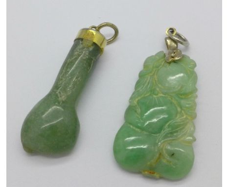 A carved jade pendant and one other carved 'fist' pendant