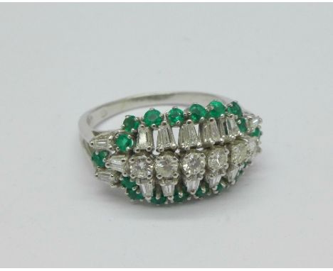 A 14ct white gold, emerald and diamond dress ring, c.1960's, 0.75ct diamond weight and 0.50ct emerald weight, weight 4.2g, O