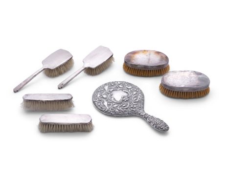 AN ART DECO SET OF SILVER BACKED VANITY BRUSHES, in simulated shagreen case; together with an embossed silver hand mirror wit
