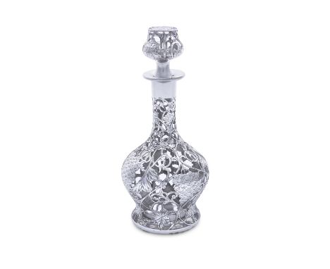 A 19TH CENTURY SILVER OVERLAID CLEAR GLASS DECANTER AND STOPPER, of baluster form, the pierced and engraved overlaid silver f