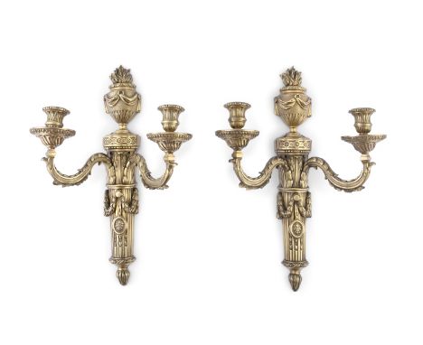 A PAIR OF FRENCH CAST BRASS WALL SCONCES, in Louis seize style, each with classical back plate and two scroll arms and upturn