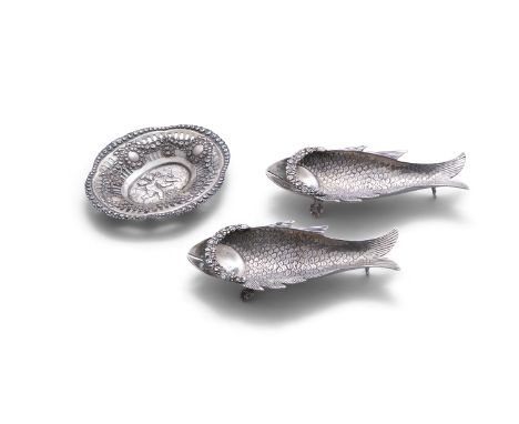 A PAIR OF CONTINENTAL NOVELTY WHITE METAL DISHES, each modelled in the form of a fish with serrated fin edges, the bowls inci