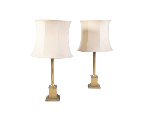 A PAIR OF BRASS CORINTHIAN COLUMN TABLE LAMPS, raised plinth bases, with cream shades. 46cm to light socket