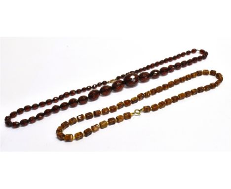TWO VINTAGE NECKLACES  A black Cherry coloured plastic necklace comprising of graduated faceted oval plastic beads, the large