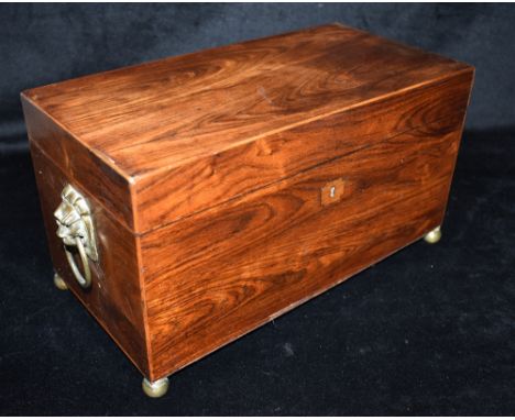 A 19TH CENTURY ROSEWOOD TEA CADDY  with lion mask ring handles, the interior with twin compartments and associated mixing bow