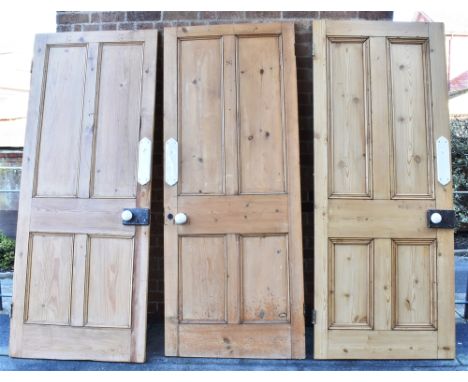 THREE VICTORIAN RECLAIMED PINE INTERNAL DOORS  of four panelled construction, each with original locks, ceramic knobs and fin