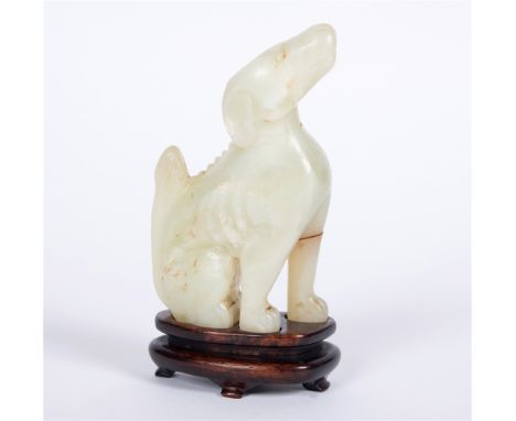 A CHINESE CARVED JADE FIGURE modelled as a seated dog, on conforming hardwood stand, 14cm high overall Condition Report : one