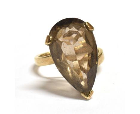 VINTAGE 9CT GOLD SMOKY QUARTZ COCKTAIL RING The pear cut stone measuring 2.2cm X 1cm at mid point width, cross over mounted o